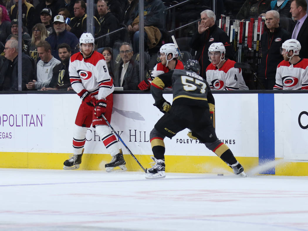 Vegas Golden Knights left wing David Perron (57) handles the puck as Carolina Hurricanes defenseman Noah Hanifin (5) tries to defend during the first period of a NHL game in Las Vegas, Tuesday, De ...