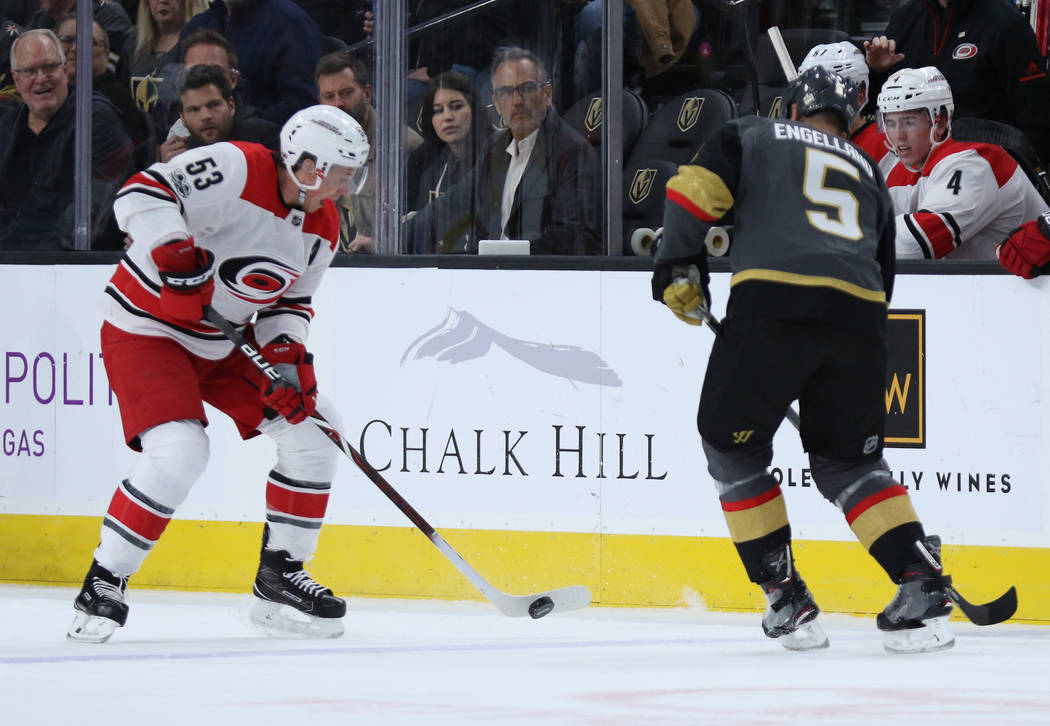 Carolina Hurricanes left wing Jeff Skinner (53) handles the puck as Vegas Golden Knights defenseman Deryk Engelland (5) pursues him during the first period of a NHL game in Las Vegas, Tuesday, Dec ...