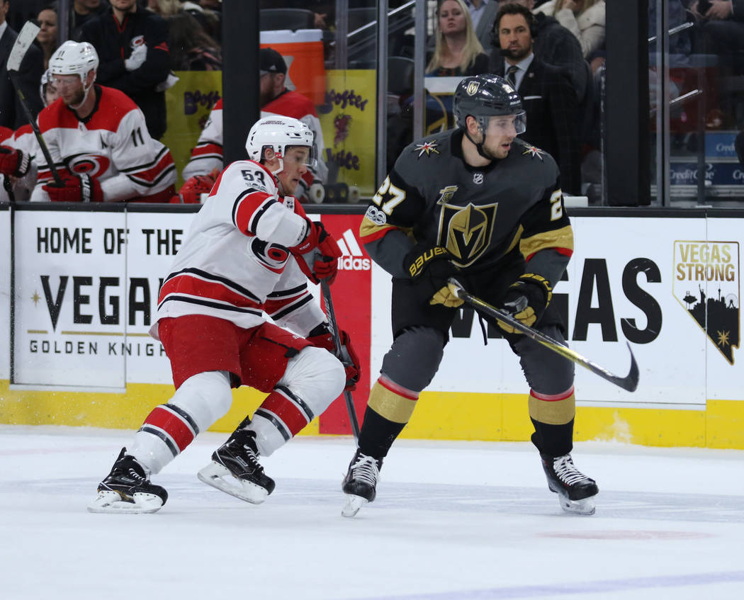 Carolina Hurricanes left wing Jeff Skinner (53) shoots the puck away from Vegas Golden Knights defenseman Shea Theodore (27) during the first period of a NHL game in Las Vegas, Tuesday, Dec. 12, 2 ...