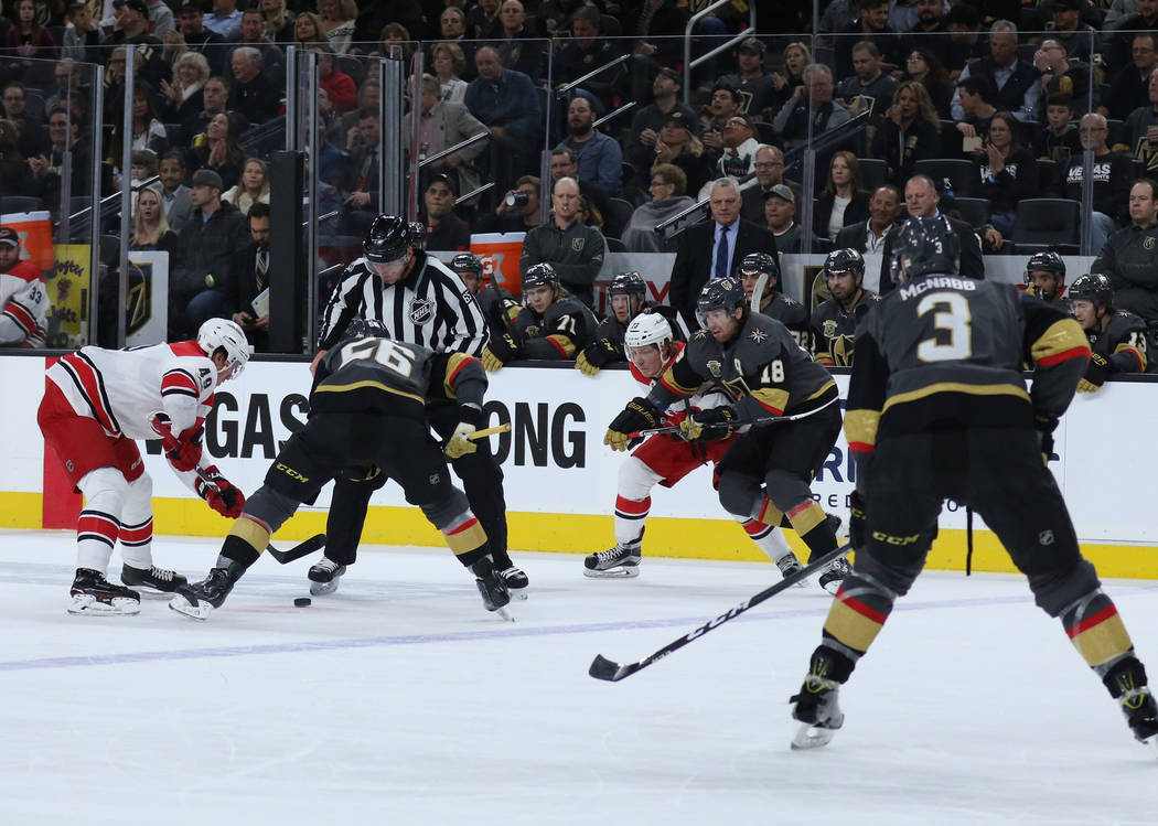 Vegas Golden Knights left wing Erik Haula (56) and Carolina Hurricanes center Victor Rask (49) face-off during the first period of a NHL game in Las Vegas, Tuesday, Dec. 12, 2017. Heidi Fang Las V ...