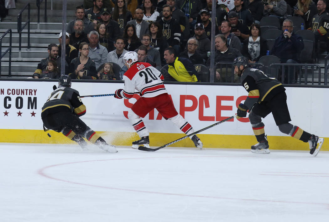 Vegas Golden Knights center Oscar Lindberg (24) skates towards the puck as Carolina Hurricanes right wing Sebastian Aho (20) and defenseman Deryk Engelland (5) skate toward the action during the f ...