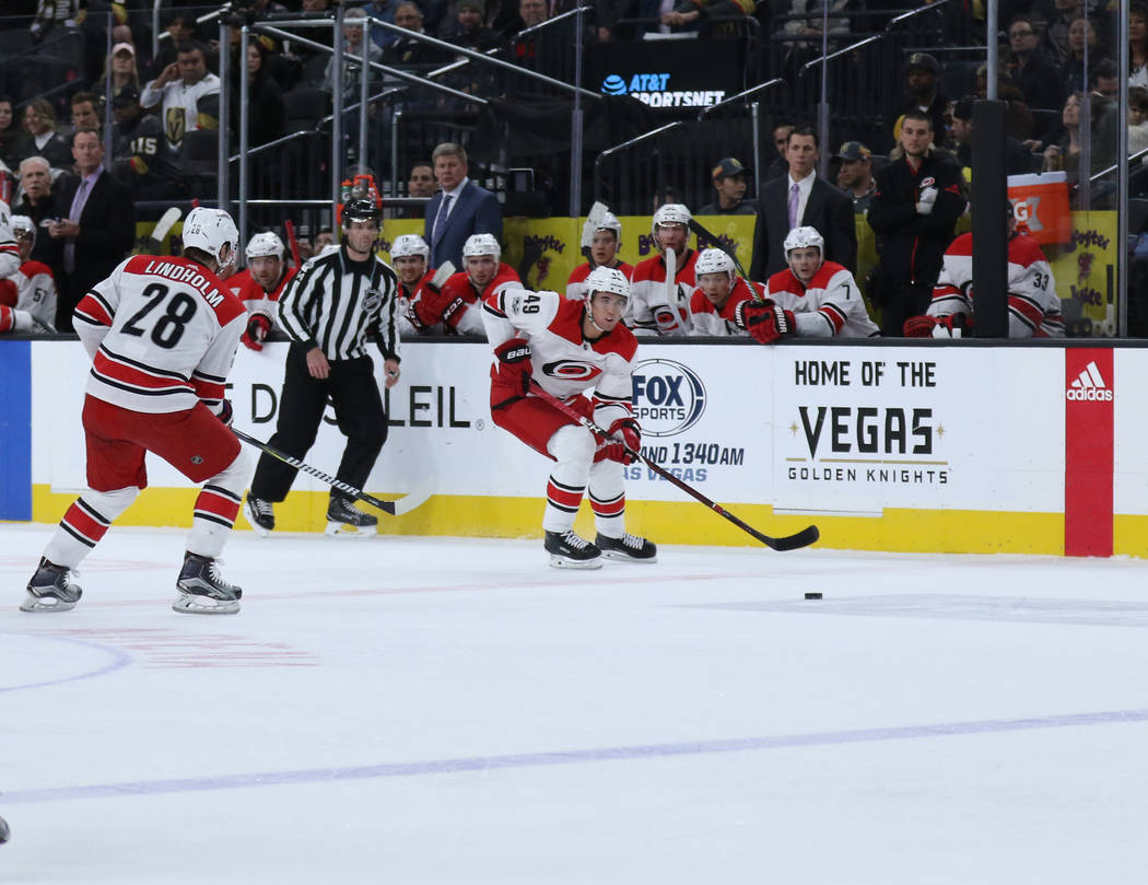 Carolina Hurricanes center Victor Rask (49) skates towards the Vegas Golden Knights goal as center Elias Lindholm (28) follows him during the first period of a NHL game in Las Vegas, Tuesday, Dec. ...