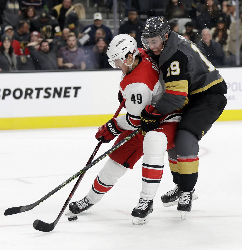 Carolina Hurricanes center Victor Rask (49) and Vegas Golden Knights right wing Reilly Smith get wrapped up during the third period of an NHL hockey game Tuesday, Dec. 12, 2017, in Las Vegas. (AP  ...