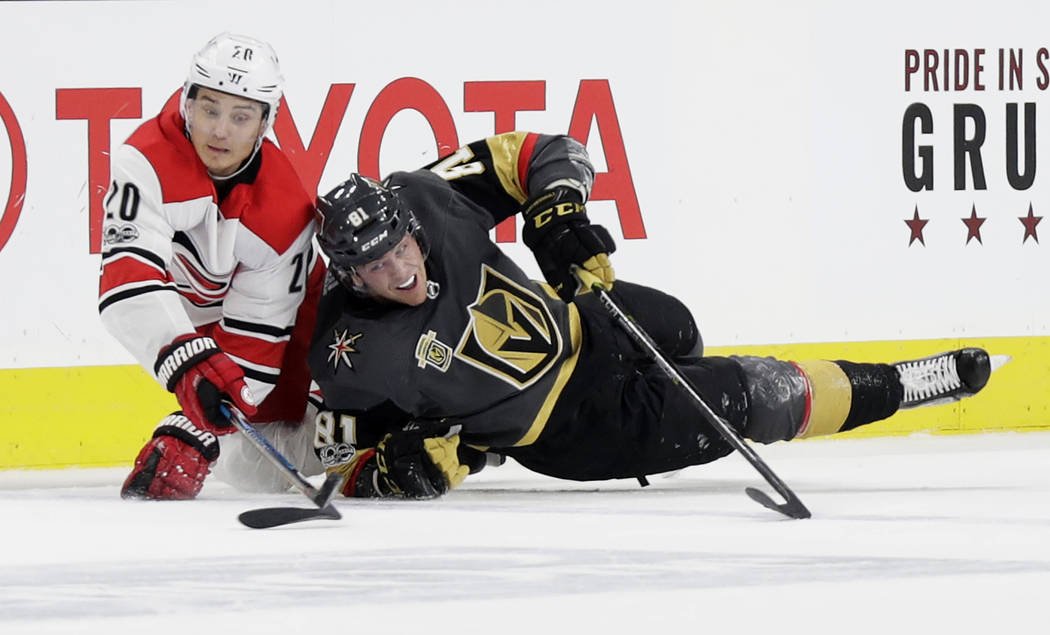 Carolina Hurricanes right wing Sebastian Aho (20) and Vegas Golden Knights center Jonathan Marchessault vies for a loose puck during the third period of an NHL hockey game Tuesday, Dec. 12, 2017,  ...
