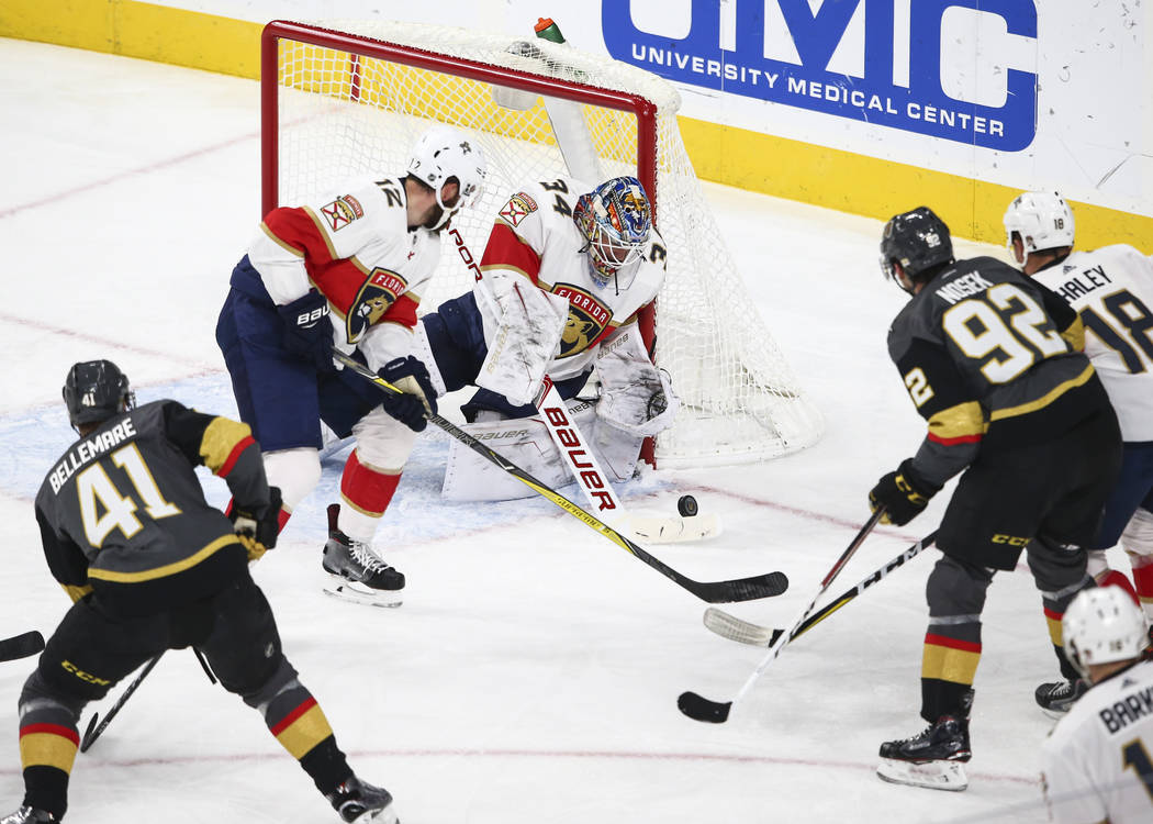 Florida Panthers goalie James Reimer (34), with help from Ian McCoshen (12), defends as the Golden Knights attempt to score during an NHL hockey game at T-Mobile Arena in Las Vegas on Sunday, Dec. ...