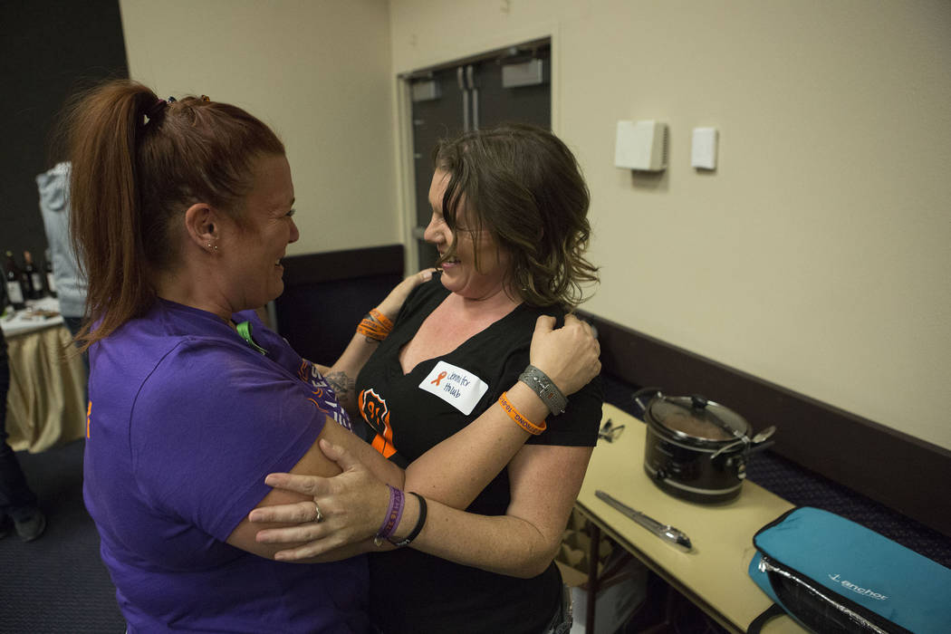 Heather Goose, left, and Jennifer Holub embrace after meeting for the first time in real life during a Thanksgiving dinner for Route 91 Harvest festival survivors at the Henderson Convention Cente ...