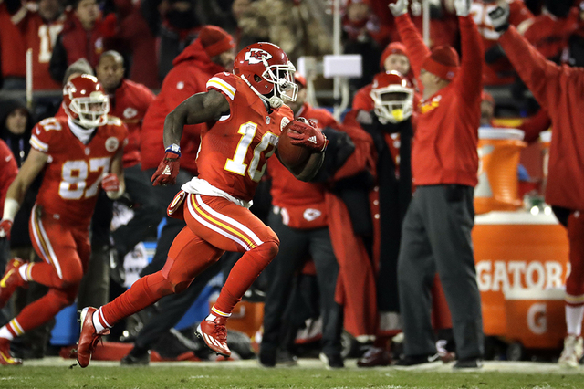 Kansas City Chiefs wide receiver Tyreek Hill (10) returns a kickoff ball for a touchdown during the first half of an NFL football game against the Oakland Raiders in Kansas City, Mo., Thursday, De ...