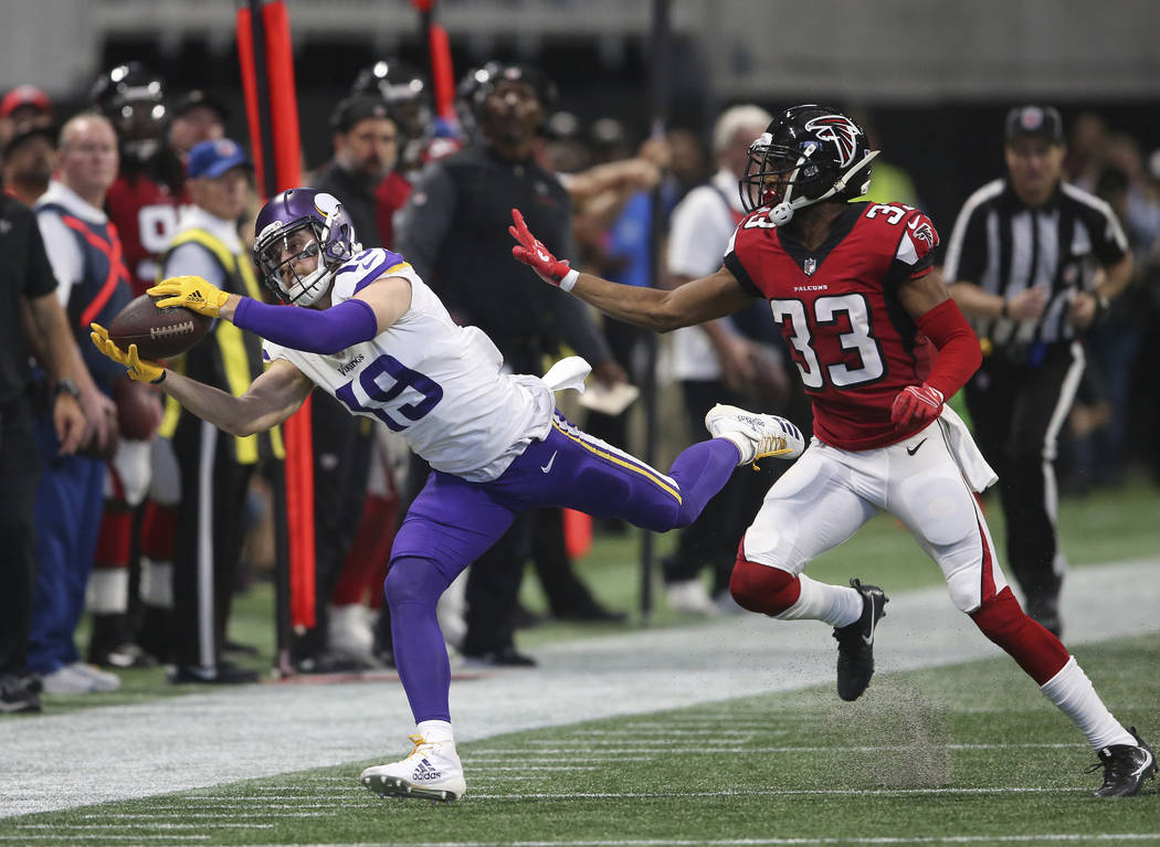 Minnesota Vikings wide receiver Adam Thielen (19) makes the catch but out of bounds against Atlanta Falcons defensive back Blidi Wreh-Wilson (33) during the first half of an NFL football game, Sun ...