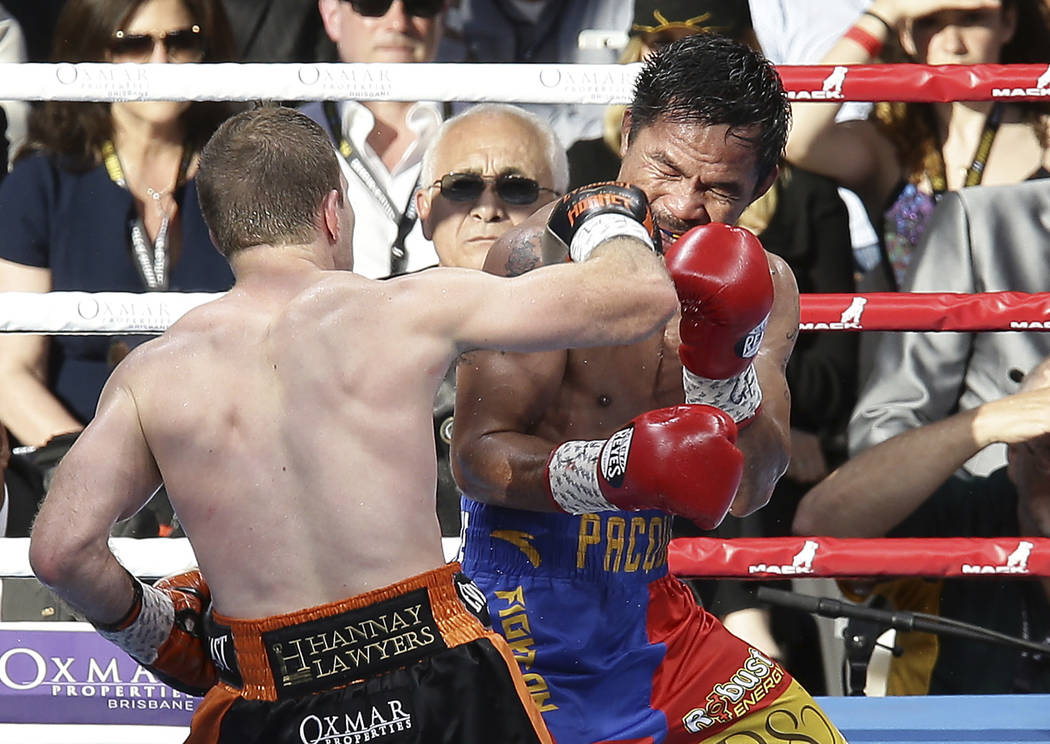 Jeff Horn of Australia, left,  lands a right to Manny Pacquiao of the Philippines during their WBO World Welterweight title fight in Brisbane, Australia, Sunday, July 2, 2017. (AP Photo/Tertius Pi ...