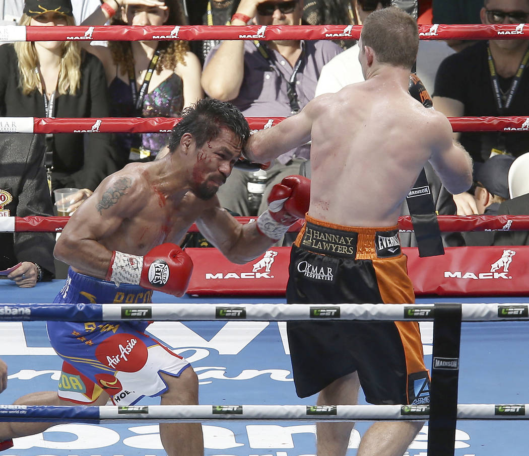 Jeff Horn of Australia, right,  lands a left to Manny Pacquiao of the Philippines during their WBO World Welterweight title fight in Brisbane, Australia, Sunday, July 2, 2017. (AP Photo/Tertius Pi ...