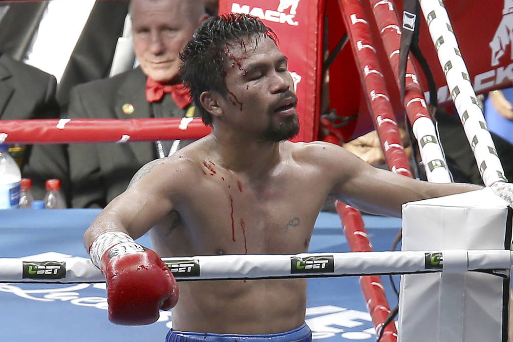 FILE - In this July 23, 2017, file photo, Manny Pacquiao, of the Philippines, reacts after his loss to Jeff Horn, of Australia, in a WBO World Welterweight title fight in Brisbane, Australia. Pacq ...