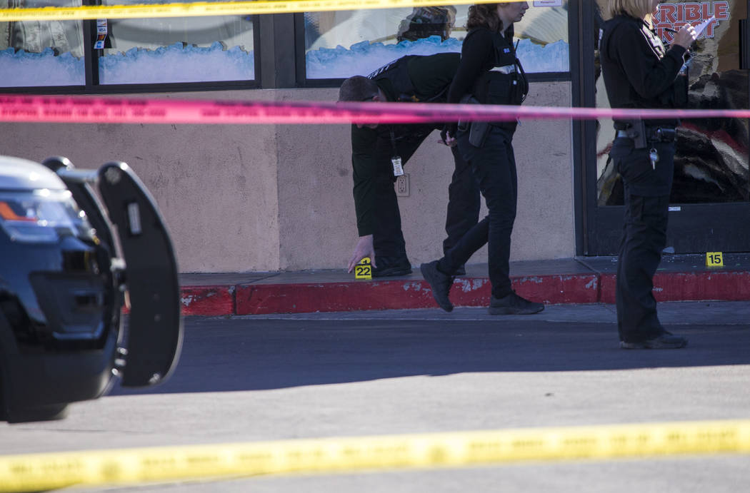 Crime scene investigators and detectives investigate a shooting incident at Terrible Herbst convenience store at the intersection of North Decatur Blvd. and Vegas Drive on Saturday, Dec. 9. 2017, ...