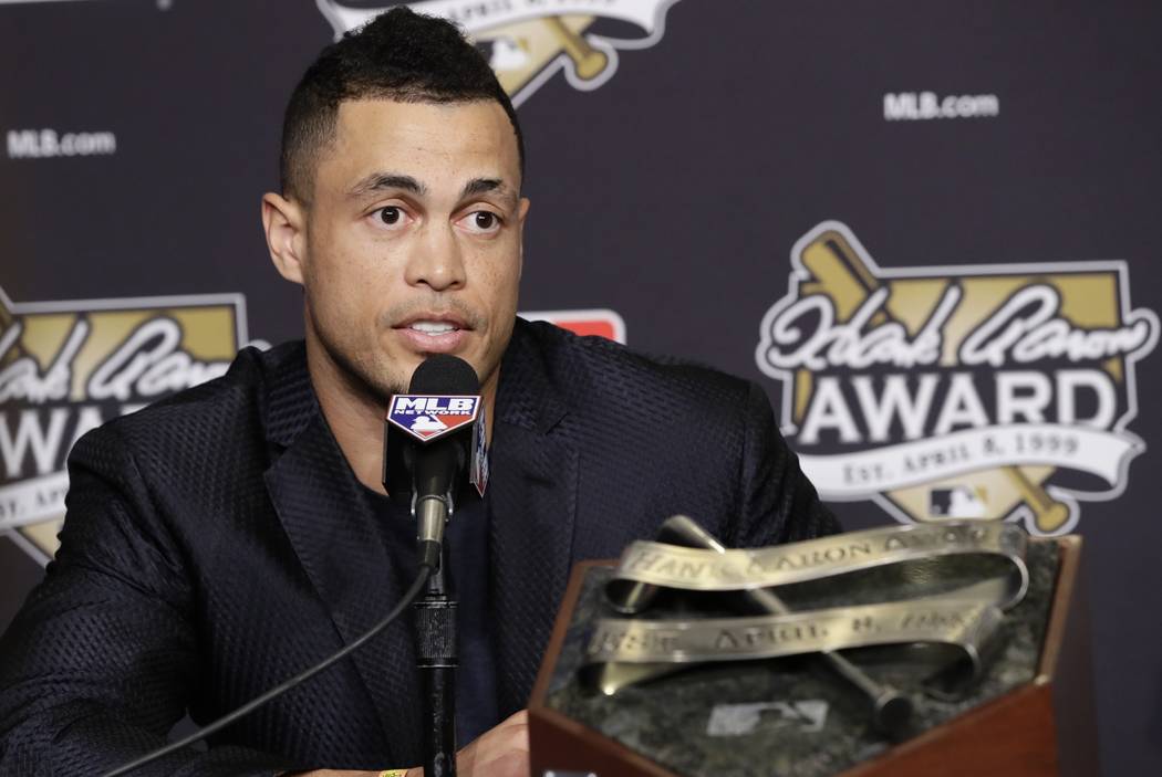 Miami Marlins' Giancarlo Stanton talks after winning the National League Hank Aaron Award at baseball's World Series Wednesday, Oct. 25, 2017, in Los Angeles. (AP Photo/Alex Gallardo)