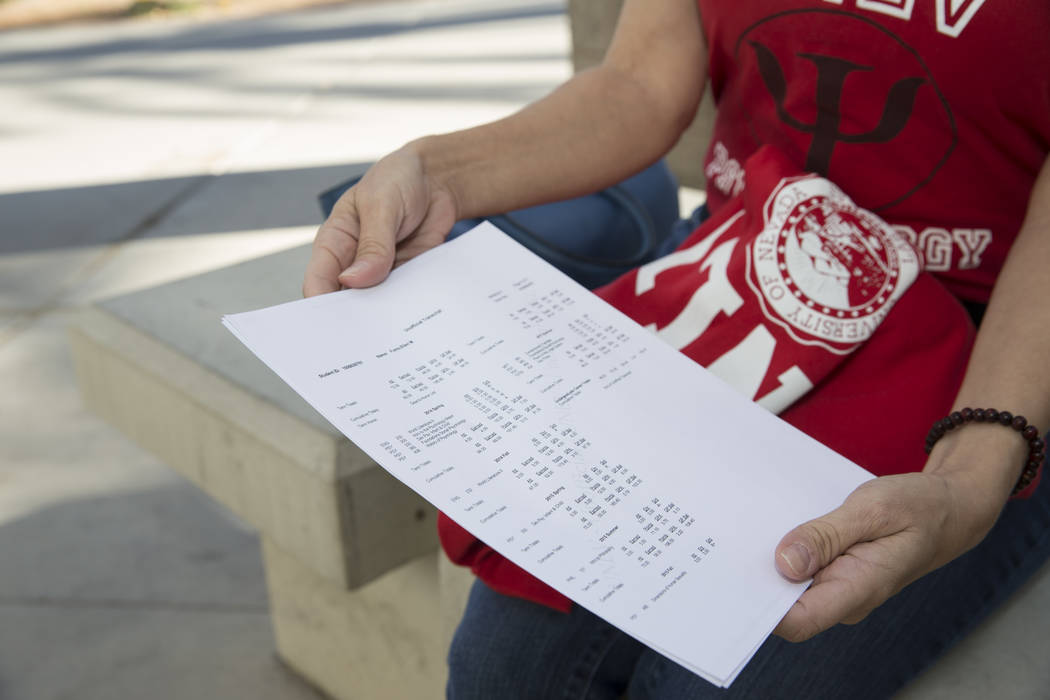 Ellen Fumo, 52, a student at UNLV with a bachelor's degree in psychology, shows her school transcript dating back to 1983, at UNLV in Las Vegas, Wednesday, Dec. 13, 2017. Erik  ...
