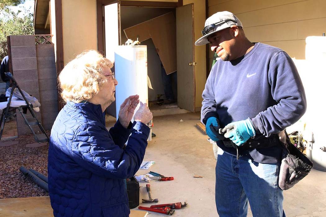 Louise Jones, 87-year-old U.S. Air Force veteran, chats with Abraham Gonzalez outside her Las Vegas home Tuesday, Dec. 12, 2017. Rebuilding Together, a nationwide non-profit organization, coordina ...