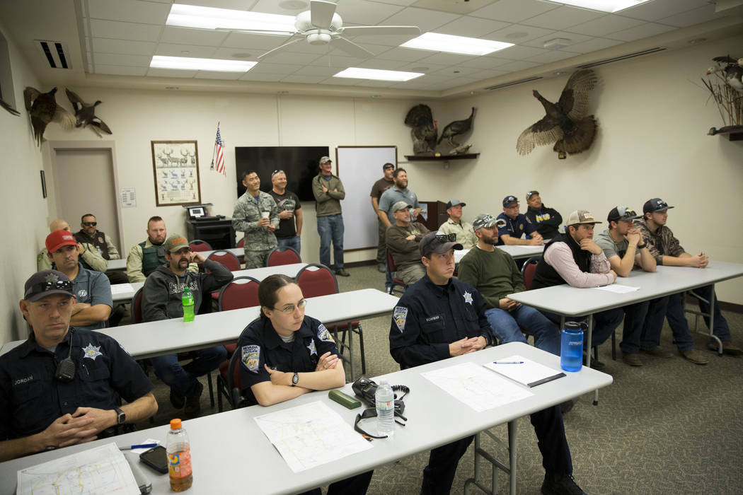 People attend an orientation at the Clark County Shooting Complex for hunters randomly picked for the annual bighorn sheep hunt inside the Nevada Test and Training Range, in Las Vegas, Friday, Dec ...