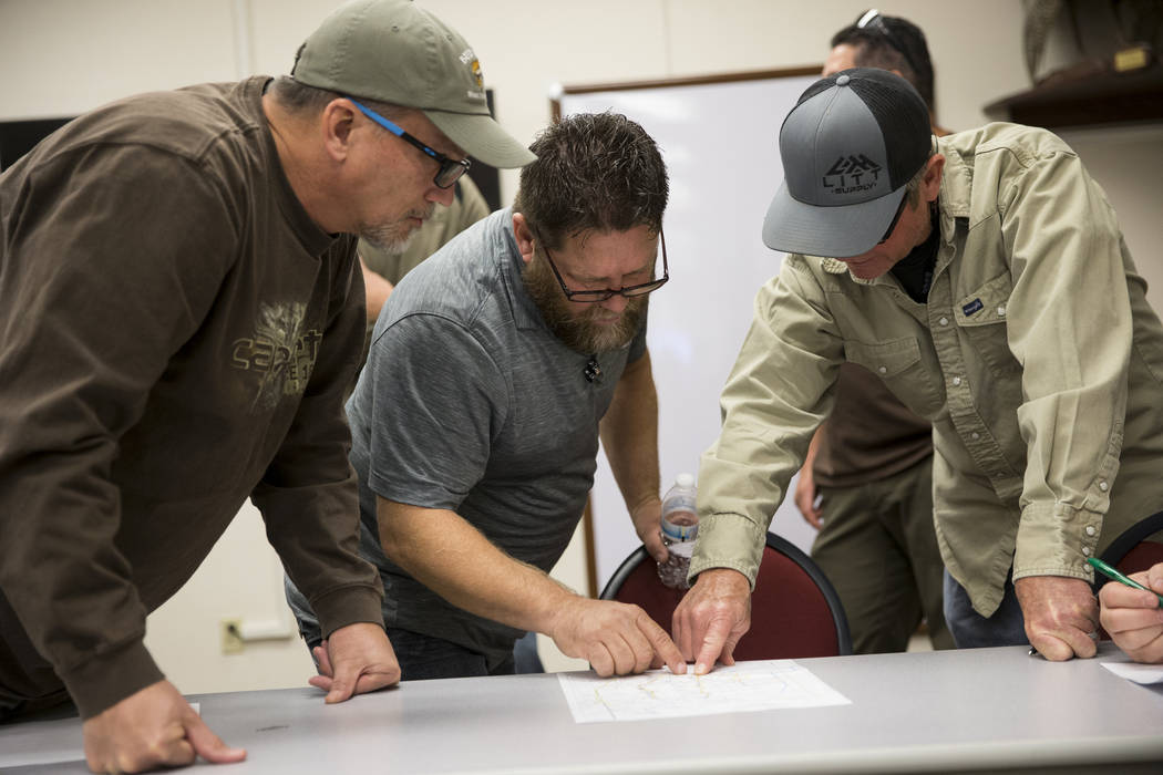 John Harris, from left, of Henderson, Dave Raynor, of Boulder City, and Darrel Leavitt, of Las Vegas, during an orientation at the Clark County Shooting Complex for hunters randomly picked for the ...