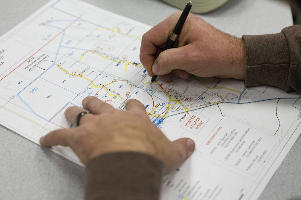 Patrick White of Reno makes a note in his map during an orientation at the Clark County Shooting Complex for hunters randomly picked for the annual bighorn sheep hunt inside the Nevada Test and Tr ...