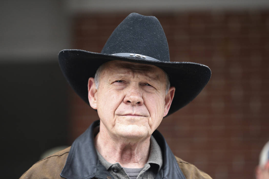 U.S. Senate candidate Roy Moore speaks to the media after he rode in on a horse to vote, Tuesday, Dec. 12, 2017, in Gallant, Ala. Alabama voters are deciding between Moore, former chief justice of ...