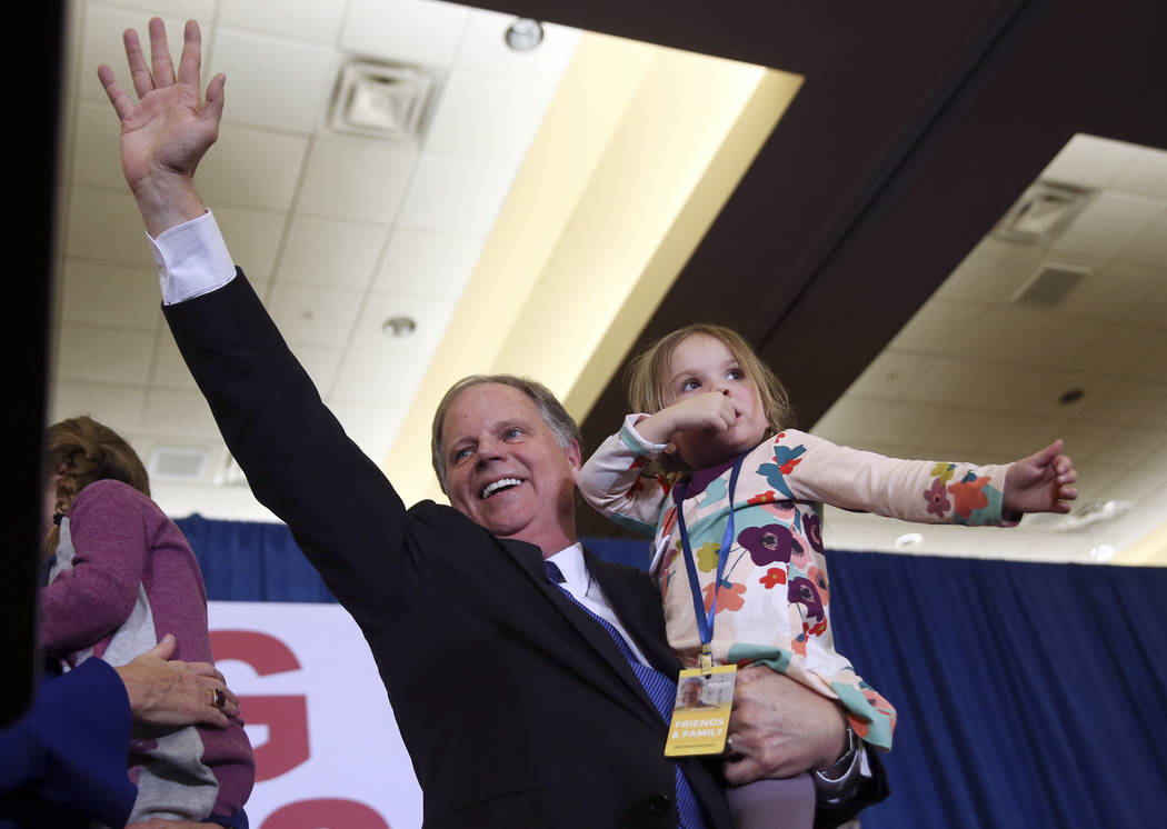 Doug Jones waves to supporters before speaking during an election-night watch party Tuesday, Dec. 12, 2017, in Birmingham, Ala. Jones won election to the U.S. Senate from Alabama, dealing a politi ...