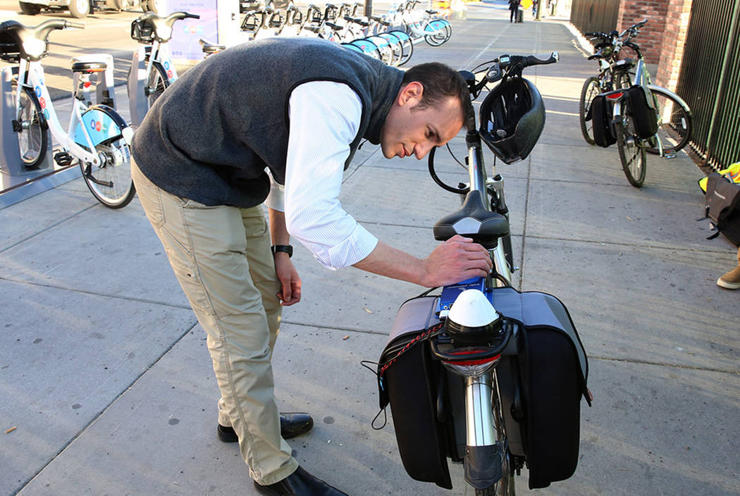 Alessandron Negri, software engineer at Charles River Analytics, demonstrates bicycling safety technology at the corner of Seventh Street and Carson Street Wednesday, Dec. 13, 2017, in Las Vegas.  ...