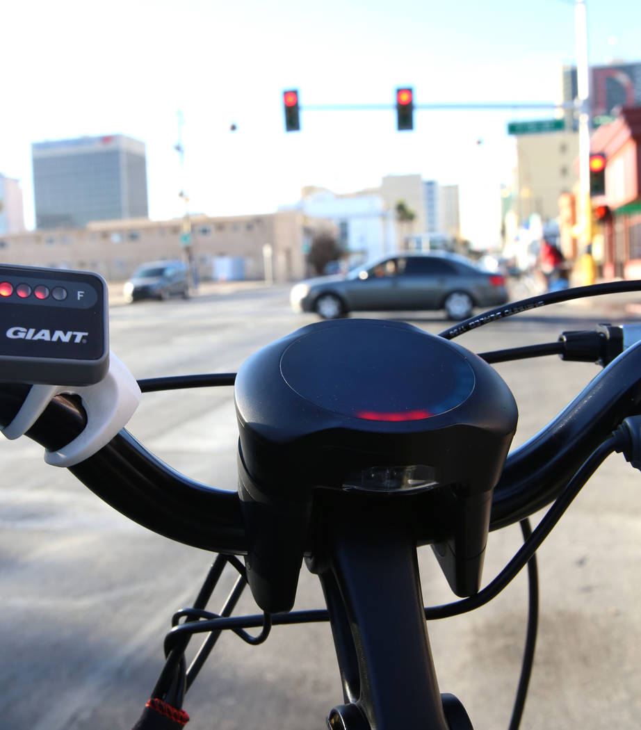 A red light displayed on a prototype bicycle notifies riders of an upcoming traffic signal as software developers from Charles River Analytics demonstrate bicycling safety technology at the corner ...
