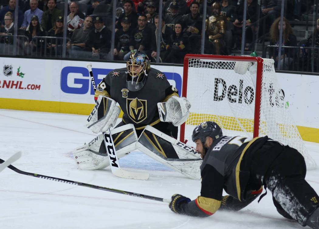 Vegas Golden Knights defenseman Deryk Engelland (5) dives near Vegas Golden Knights goalie Marc-Andre Fleury (29) as he watches for the Carolina Hurricanes to attempt a goal during the first perio ...
