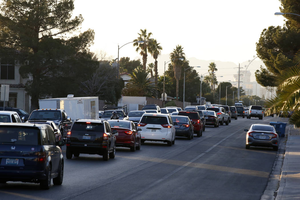 Traffic backs up on Viking road near the intersection of Eastern Avenue and Flamingo Road where a multiple-vehicle crash left three children dead Wednesday, Dec. 13, 2017. Police said six people w ...