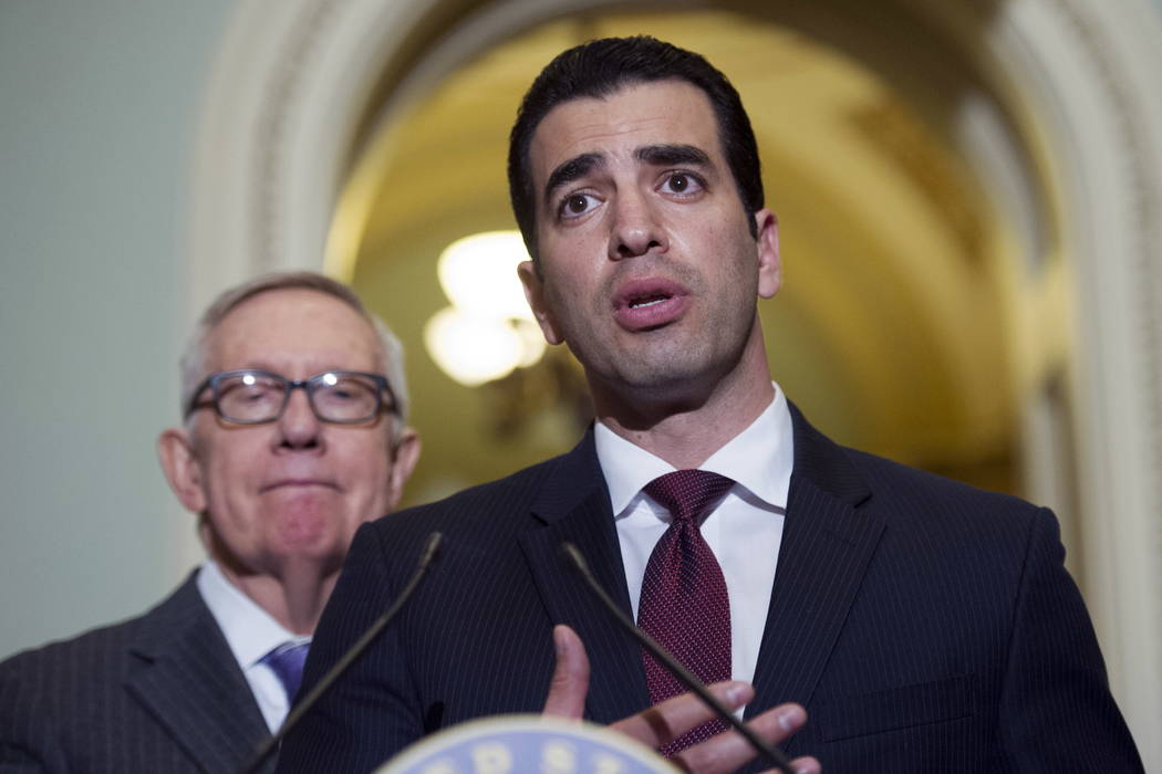 Rep.-elect Ruben Kihuen, D-Nev.,right, speaks with reporters as Sen. Harry Reid, D-Nev., left, listens on Capitol Hill in Washington, Nov. 14, 2016 . The chairman of the House Democrats' campaign ...