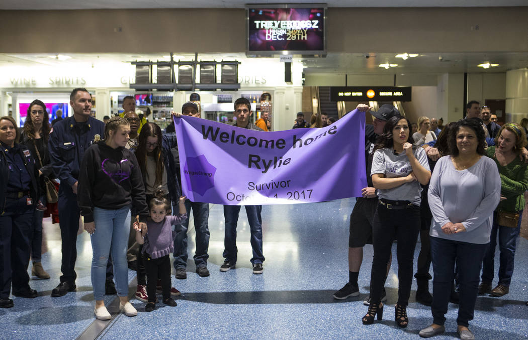 Friends and family members wait for the arrival of Rylie Golgart, 19, at McCarran International Airport in Las Vegas on Friday, Dec. 15, 2017. Golgart, a victim in the Oct. 1 shooting, spent two m ...