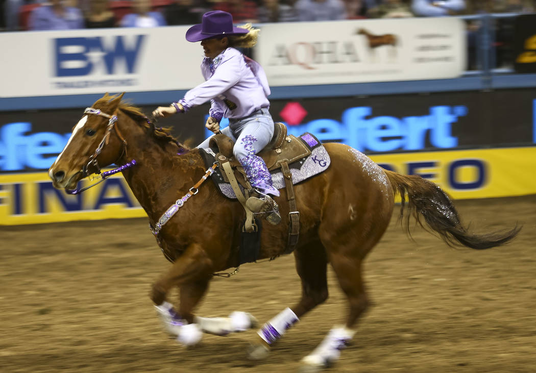 Kathy Grimes of Medical Lake, Washington rides in the barrel racing competition during the eighth go-round of the National Finals Rodeo, Thursday, Dec. 14, 2017, at the Thomas & Mack Center in ...