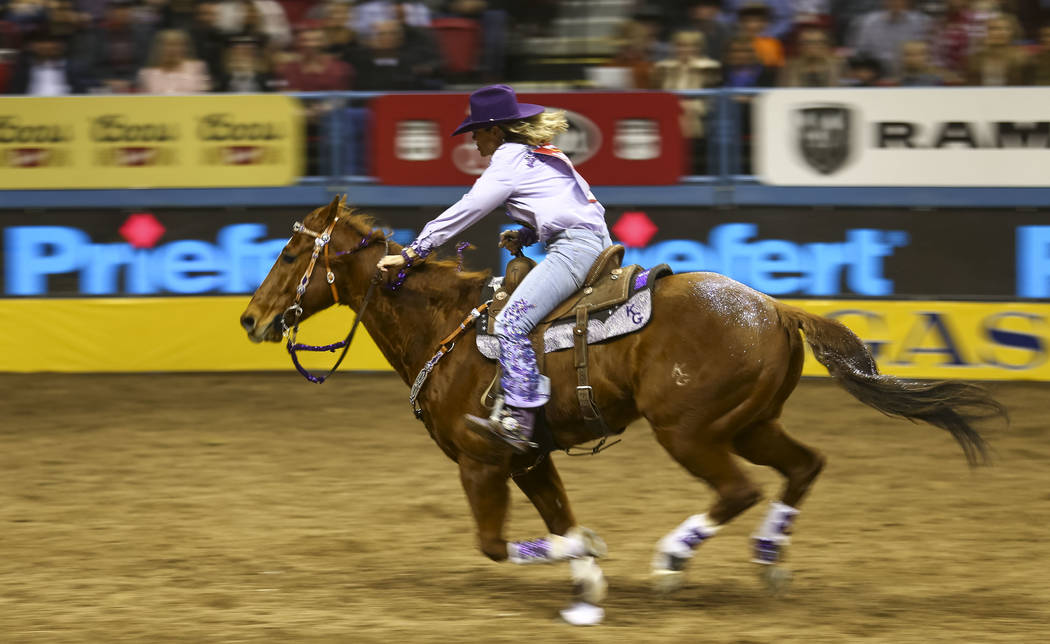 Kathy Grimes of Medical Lake, Washington rides in the barrel racing competition during the eighth go-round of the National Finals Rodeo, Thursday, Dec. 14, 2017, at the Thomas & Mack Center in ...