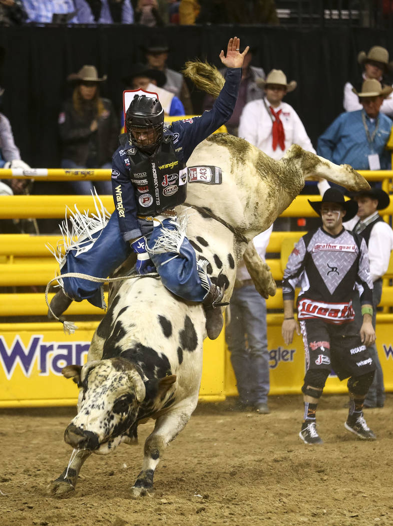 Joe Frost of Randlett, Utah rides Blizzard in the bull riding competition during the eighth go-round of the National Finals Rodeo, Thursday, Dec. 14, 2017, at the Thomas & Mack Center in Las V ...