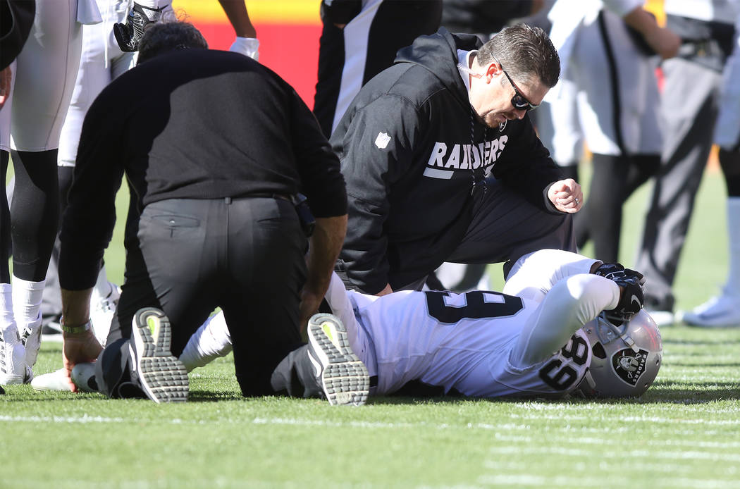 Oakland Raiders wide receiver Amari Cooper (89) is looked at by trainers after being injured on a play during the first half of a NFL game against the Kansas City Chiefs in Kansas City, Mo., Sunda ...