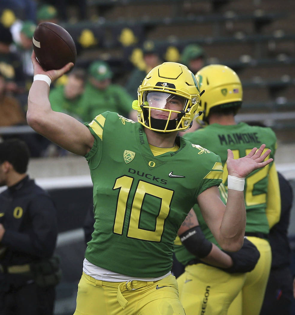 Oregon quarterback Justin Herbert warms up before the the team's NCAA  college football game against Arizona on Saturday, Nov. 18, 2017, in  Eugene, Ore. Herbert has been out with an injury. (AP