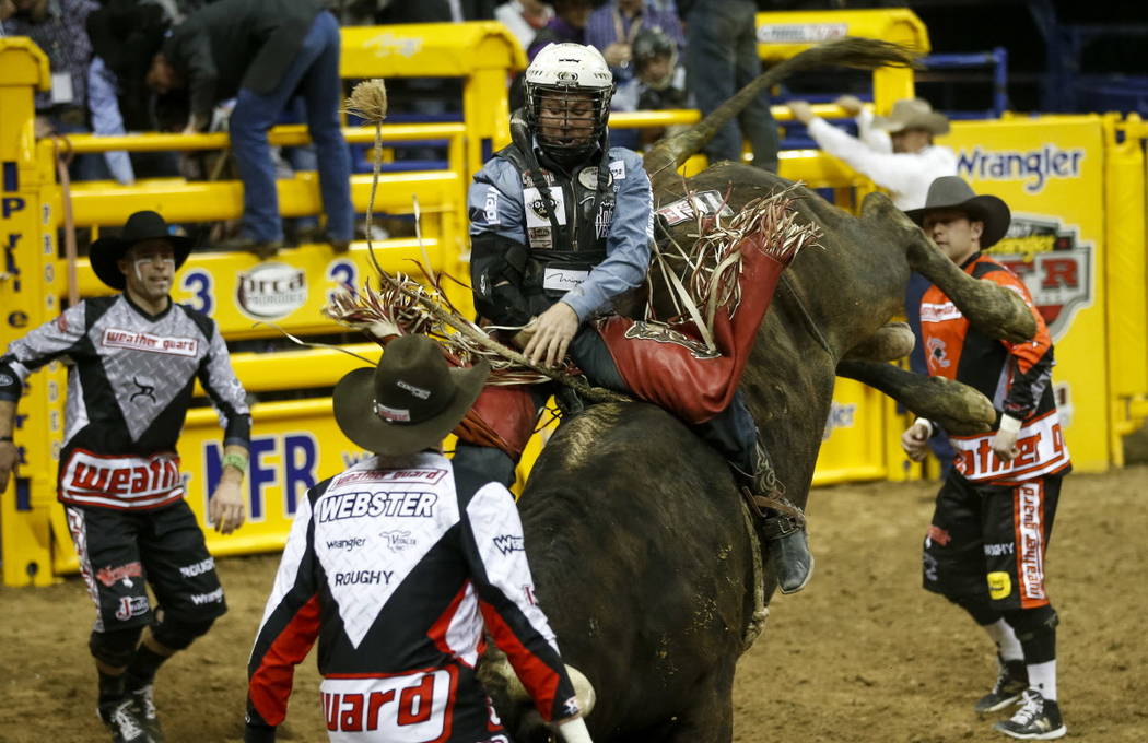 Trey Benton III of Rock Island, Texas rides Nose Bender in the bull riding competition during the ninth go-round of the National Finals Rodeo, Friday, Dec. 15, 2017, at the Thomas & Mack Cente ...
