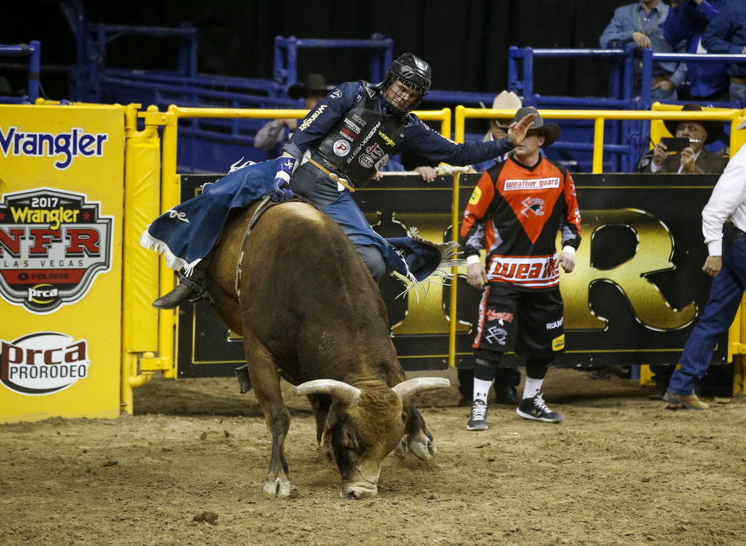 Joe Frost of Randlett, Utah rides Wild Goose in the bull riding competition during the ninth go-round of the National Finals Rodeo, Friday, Dec. 15, 2017, at the Thomas & Mack Center in Las Ve ...