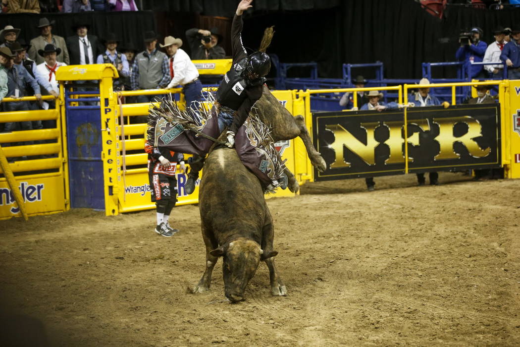 Boudreaux Campbell of Crockett, Texas rides Reveloution in the bull riding competition during the ninth go-round of the National Finals Rodeo, Friday, Dec. 15, 2017, at the Thomas & Mack Cente ...