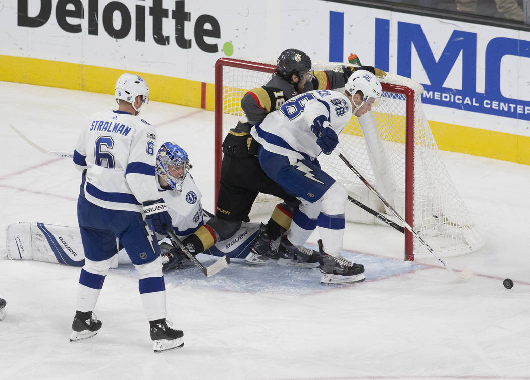 Tampa Bay goaltender Andrei Vasilevskiy  (88) and defenseman Mikhail Sergachev (98) block the shot of Golden Knights left wing James Neal (18) in the second period during the Lightning's road matc ...
