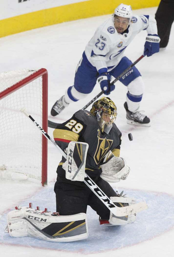 Golden Knights goaltender Marc-Andre Fleury (29) makes a save against Tampa Bay right wing J.T. Brown                  (23) in the second during Vegas' home matchup with the Lighting on Tuesday, D ...