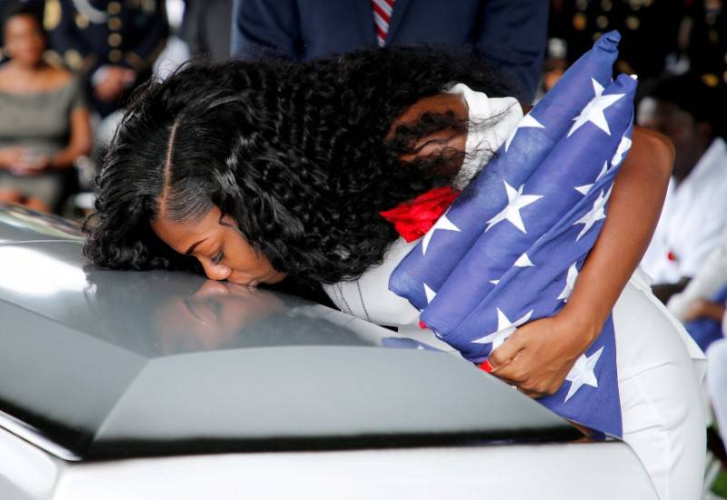 Myeshia Johnson, wife of U.S. Army Sergeant La David Johnson, who was among four special forces soldiers killed in Niger, kisses his coffin at a graveside service in Hollywood, Florida, Oct. 21, 2 ...
