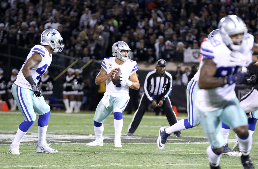 Dallas Cowboys quarterback Dak Prescott (4) drops back to pass against the Oakland Raiders during the first half of a NFL game in Oakland, Calif., Sunday, Dec. 17, 2017. Heidi Fang Las Vegas Revie ...