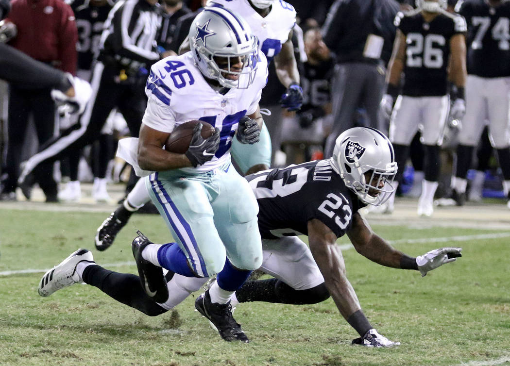 Dallas Cowboys running back Alfred Morris (46) runs with the football as Oakland Raiders cornerback Dexter McDonald (23) misses a tackle during the first half of a NFL game in Oakland, Calif., Sun ...