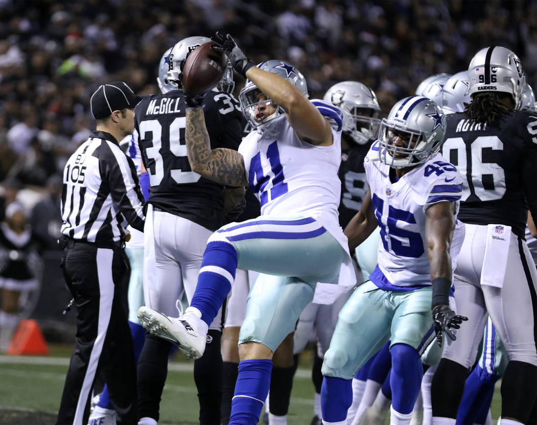 Dallas Cowboys fullback Keith Smith (41) spikes the football after running back Rod Smith (45) scores during the first half of a NFL game against the Oakland Raiders in Oakland, Calif., Sunday, De ...