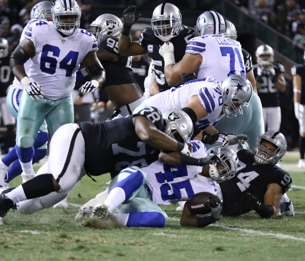 Dallas Cowboys running back Rod Smith (45) is tackled by Oakland Raiders defensive tackle Justin Ellis (78) after a run during the first half of a NFL game in Oakland, Calif.., Sunday, Dec. 17, 20 ...