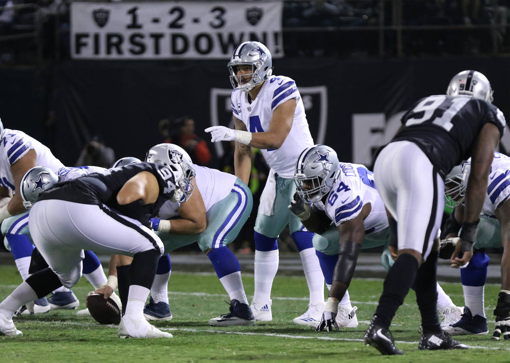 Dallas Cowboys quarterback Dak Prescott (4) calls a play at the line of scrimmage against the Oakland Raiders during the first half of a NFL game in Oakland, Calif., Sunday, Dec. 17, 2017. Heidi F ...