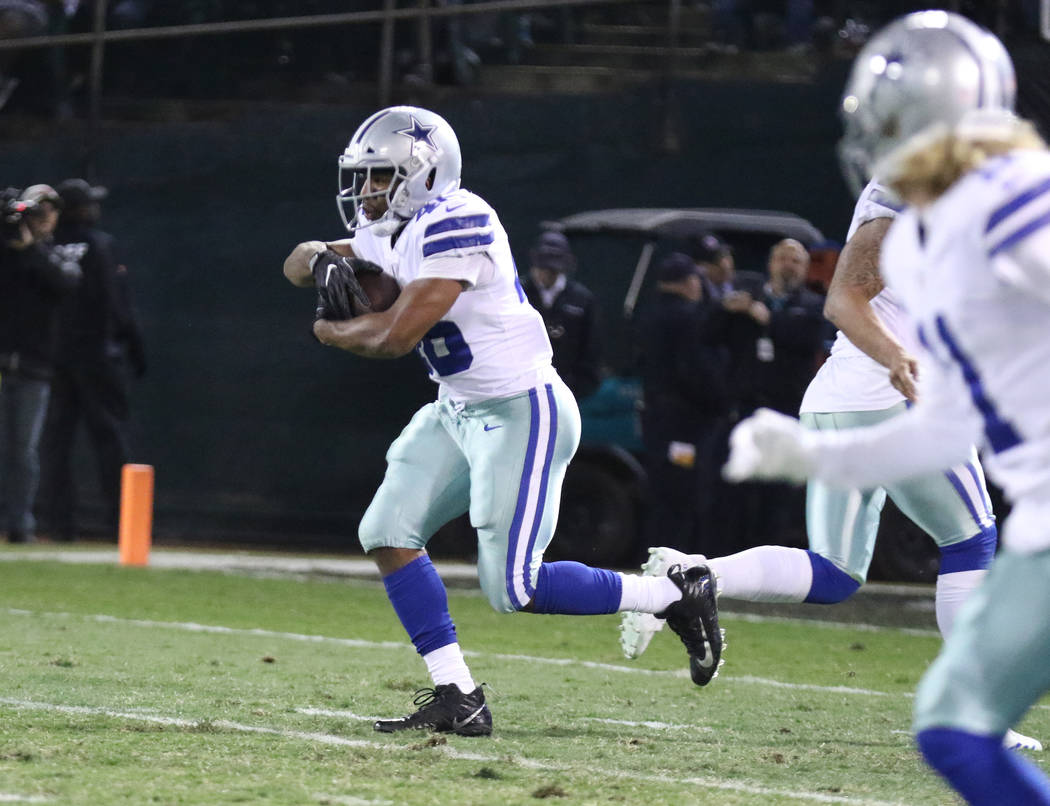 Dallas Cowboys running back Alfred Morris (46) runs with the football against the Oakland Raiders during the first half of a NFL game in Oakland, Calif., Sunday, Dec. 17, 2017. Heidi Fang Las Vega ...