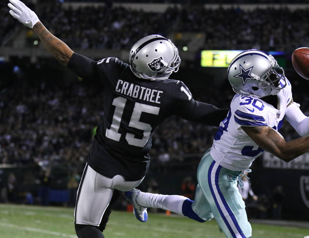 Dallas Cowboys cornerback Anthony Brown (30) deflects a pass intended for Oakland Raiders wide receiver Michael Crabtree (15) during the first half of a NFL game in Oakland, Calif., Sunday, Dec. 1 ...