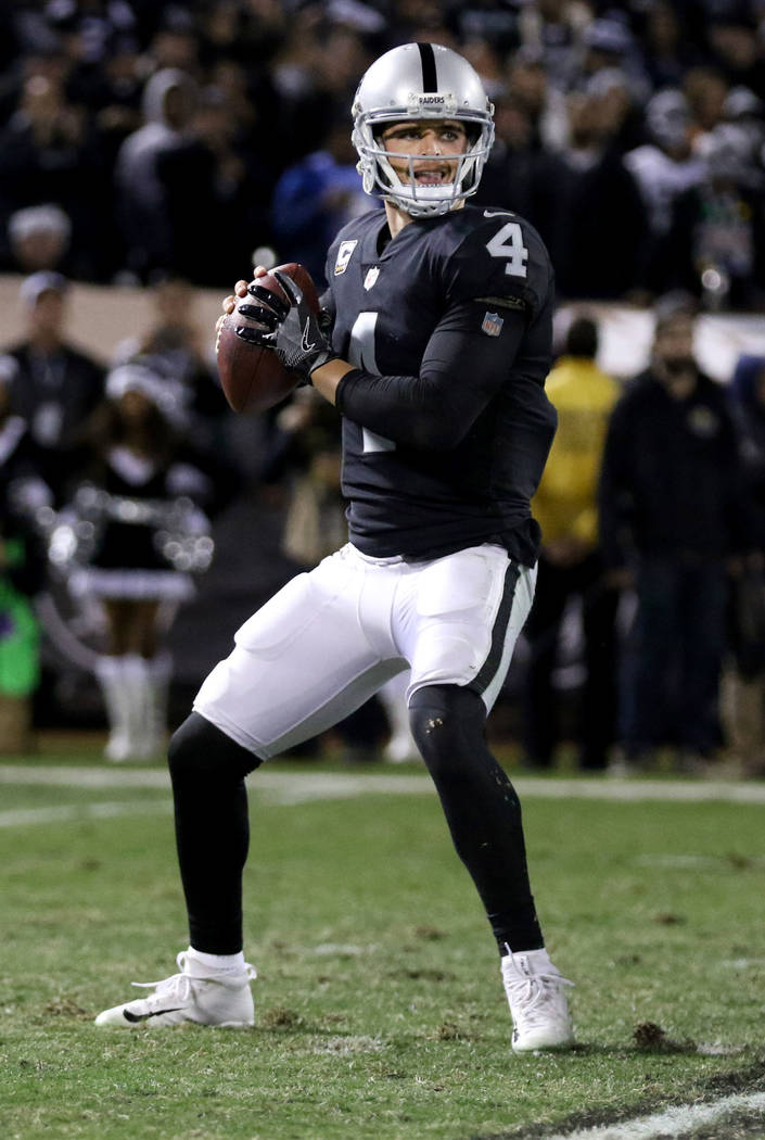 Oakland Raiders quarterback Derek Carr (4) drops back to pass during the first half of a NFL game against the Dallas Cowboys in Oakland, Calif., Sunday, Dec. 17, 2017. Heidi Fang Las Vegas Review- ...