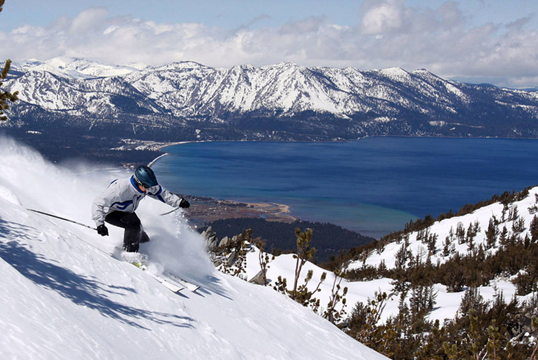 With Lake Tahoe as a backdrop, a skier kicks up some powder at Heavenly Ski Resort in South Lake Tahoe, Calif., in 2010. (AP Photo/Dino Vournas)